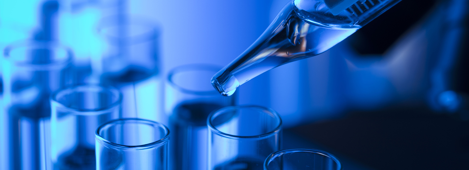 Photo of pipettes dropping into test tube.